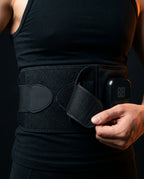 Cordless heated massage belt – hand adjusting the belt at the waist