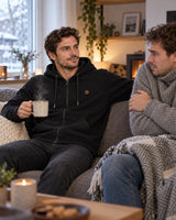 Unisex heated zip hoodie PyreFit Olivora on a winter day: at home