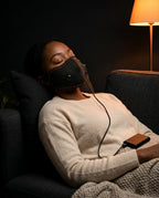 Face mask – heat or massage – woman wearing the mask in an armchair