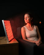LED red light panel – woman seated in front of the panel
