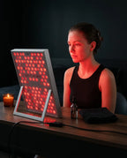 LED red light panel – man in front of the panel at a table