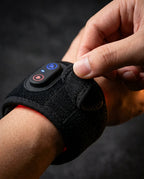 LED red light wrist band – hand on the control button of the band being worn