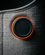 Illuminated control button on the foldable foot warmer, close-up