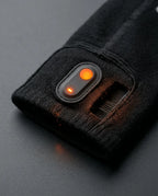 Control button on the cuff of the heated socks, detail view