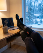 Person reading while wearing battery-powered heated socks