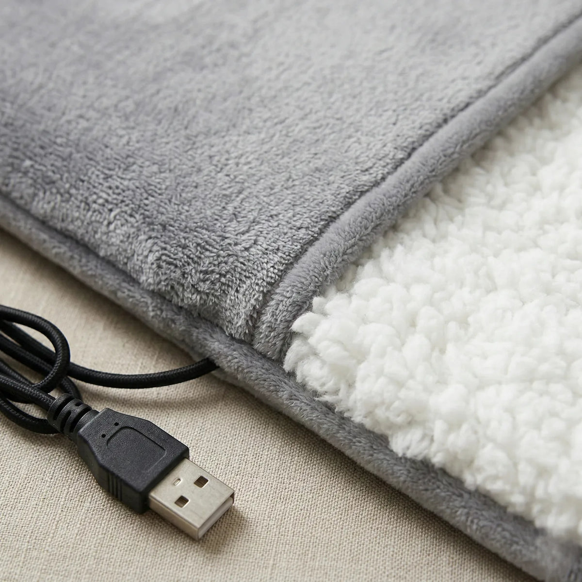 Compact USB foot warmer at the desk